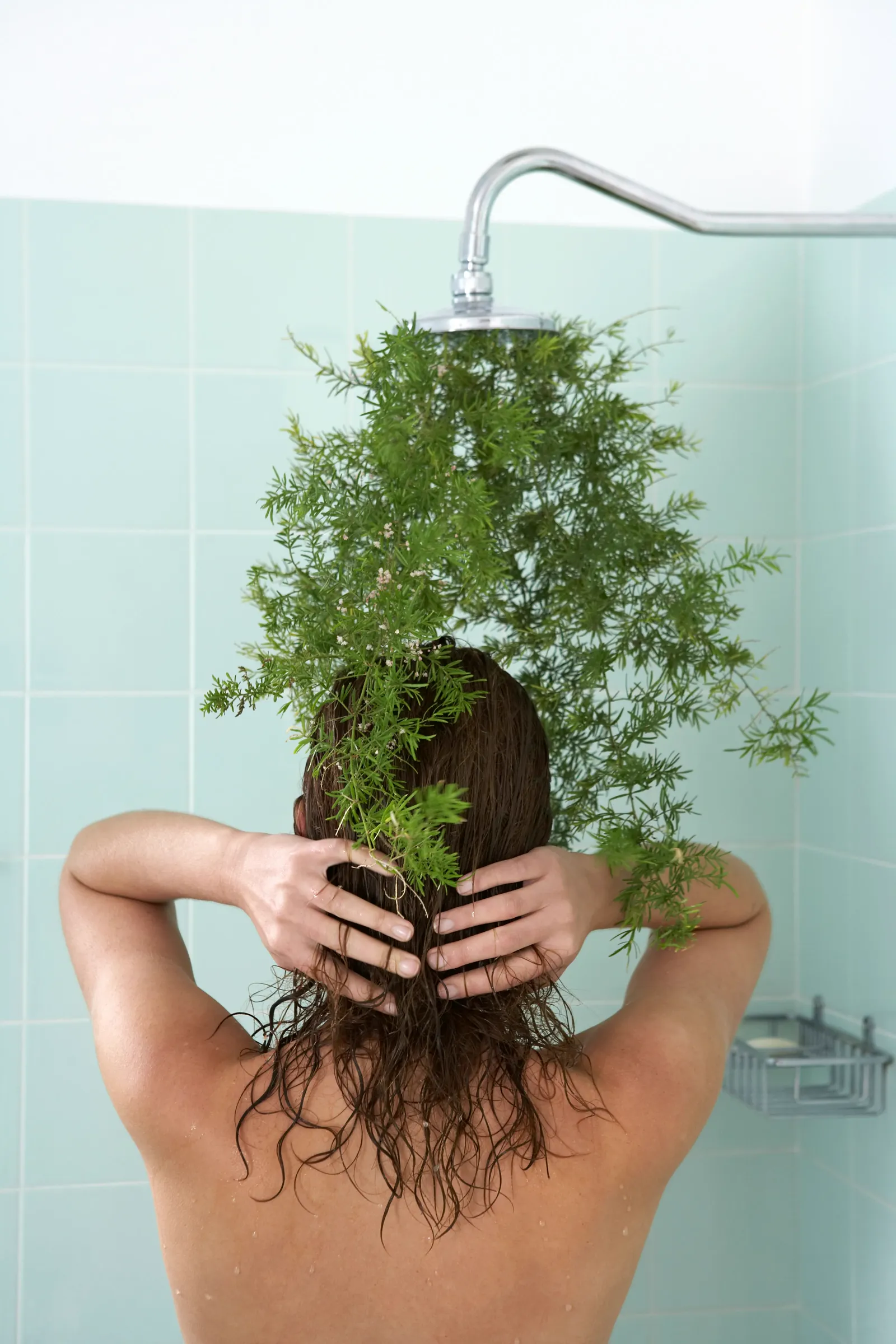 Person washing hair in shower — filter performance matters as much in the shower as at the kitchen tap, and the spec sheet tells you exactly what's covered